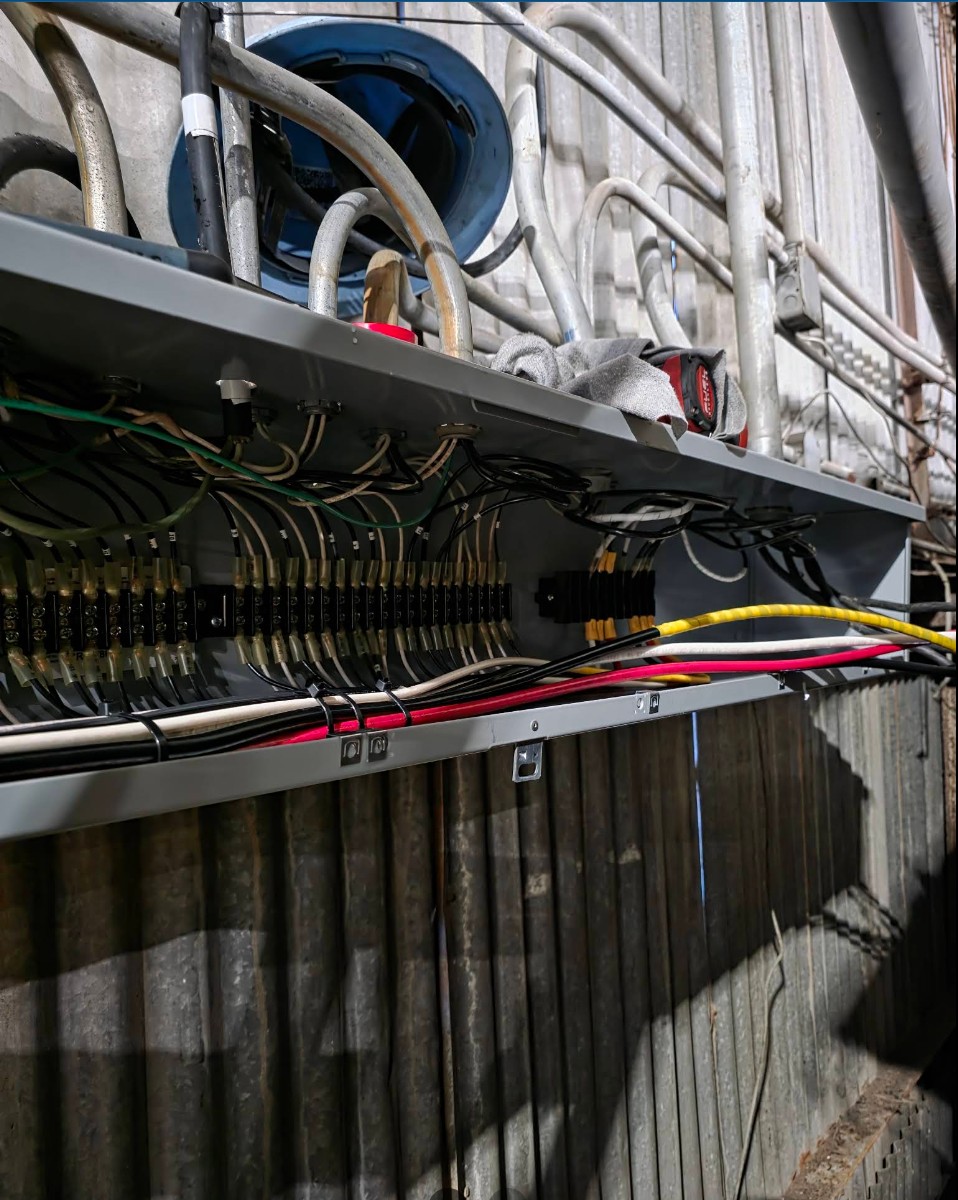 Long industrial wireway with rows of terminal blocks and organized conductor runs