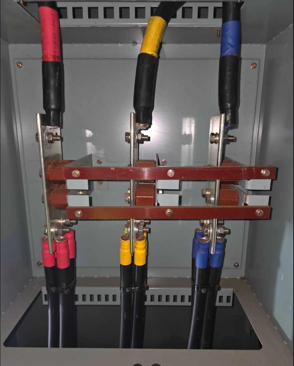 Three-phase copper busbar assembly with red, yellow and blue phase-taped cable terminations